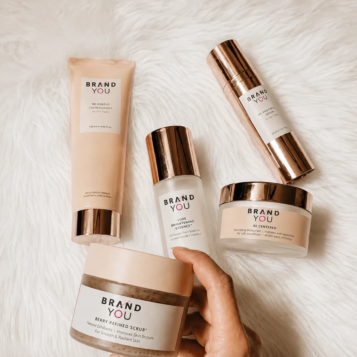 BrandYou skincare products arranged on a soft neutral surface