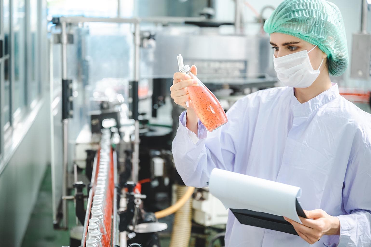 A quality specialist reviewing a skincare formula during production