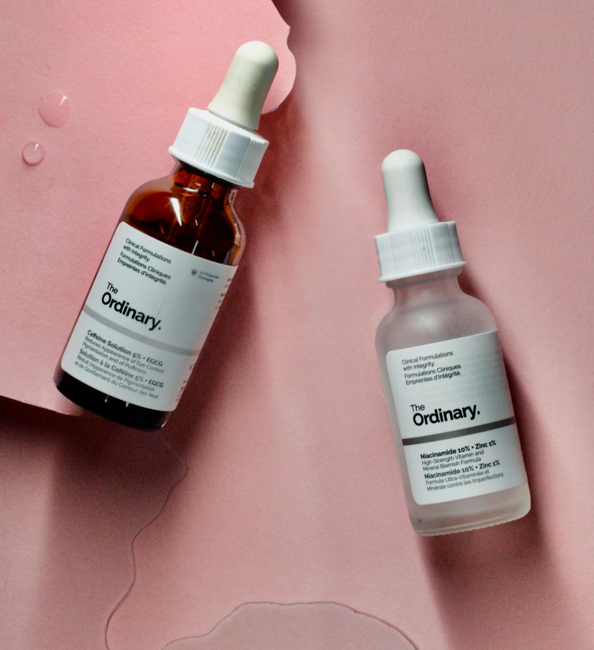 Serum bottles arranged on a skincare product backdrop